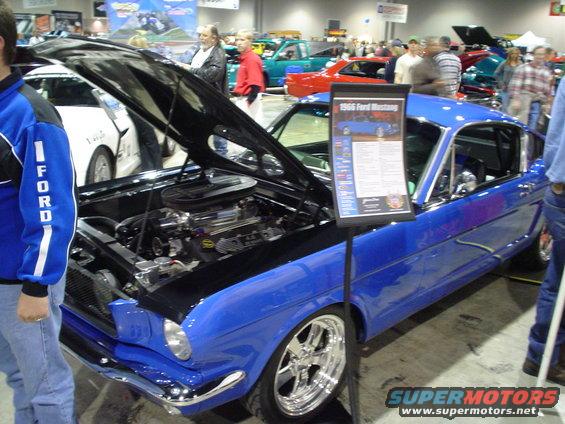 Blue 1966 Ford Mustang, 3q-front view, hood open showing engine