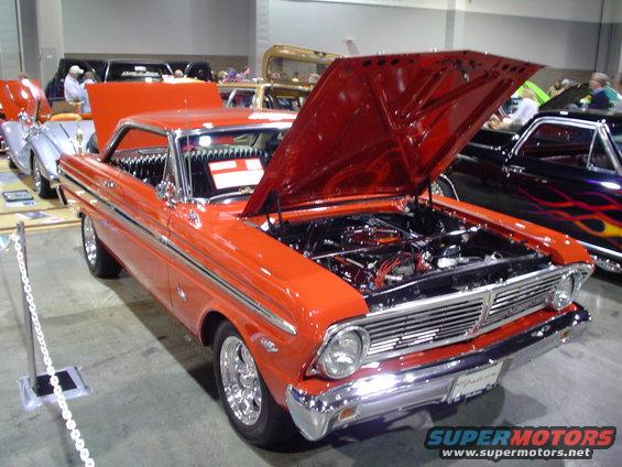 Orange 1964 Ford Falcon coupe, front 3/4 view, hood open showing engine