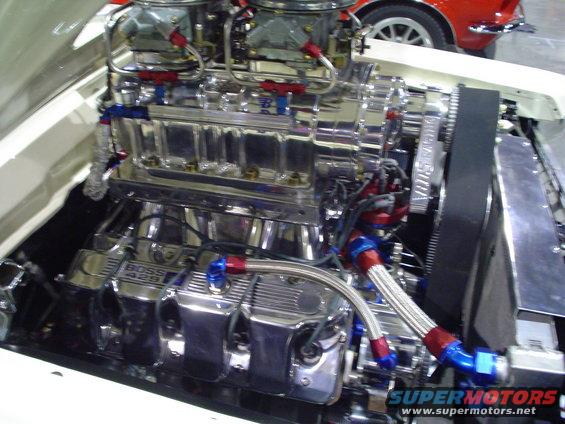 Engine bay with a polished supercharger and dual carburetors. "BOSS 429" is visible on the valve cover