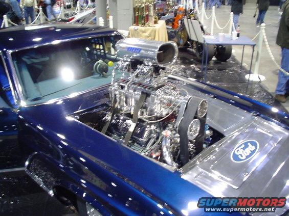 Blue car's exposed engine with Ford logo
