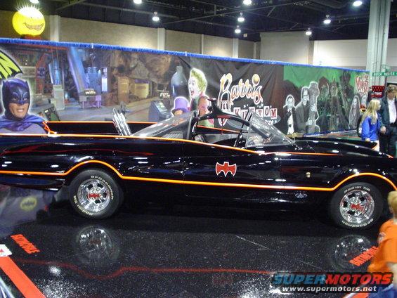 Black Batmobile with orange trim and bat symbol on the side