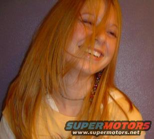 Young woman with long blonde hair laughing, eyes closed. Supermotors logo visible