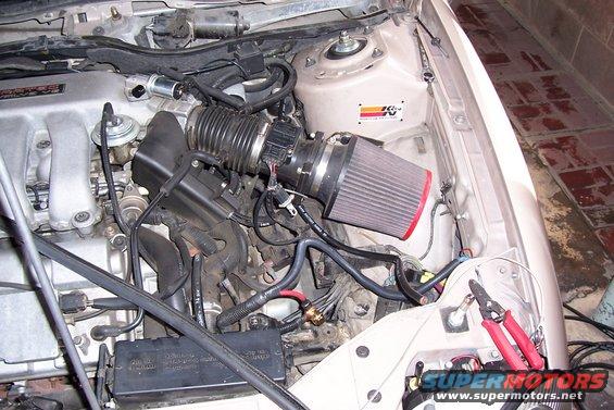 Engine bay with K&N air filter and red-handled wire cutters