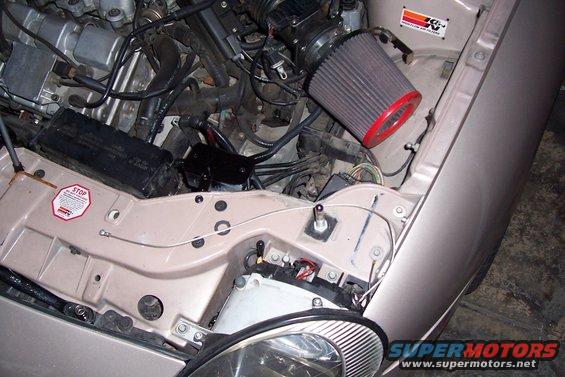 Engine bay with K&N air filter and a 'STOP' sticker