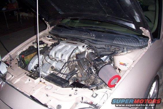 engine bay with V6 engine, aftermarket air filter, and K&N sticker