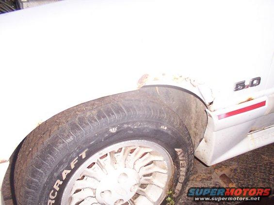 White 1988 Ford Mustang fender with "5.0" badge and tire