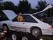 1988 Ford Mustang - White 1988 Ford Mustang on a trailer with hood and trunk open, child in the driver's seat.