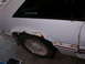 1988 Ford Mustang - This 1988 Ford Mustang shows significant rust on its rear quarter panel and lower body trim.