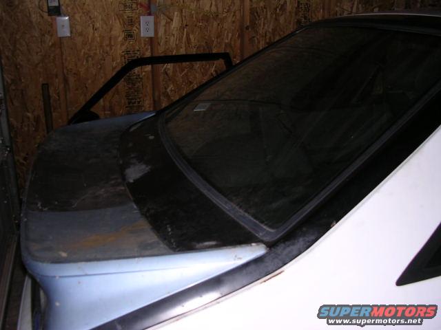 Car interior, showing dashboard and windshield area. Door is open