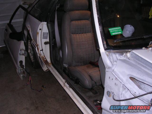 1988 Ford Mustang interior with driver's seat and open doors