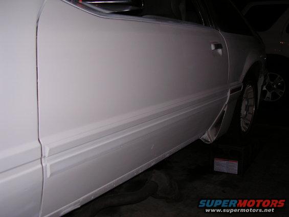 White 1988 Ford Mustang side view showing door and molding