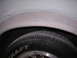 1988 Ford Mustang - A close-up view of a vehicle's wheel well and tire, showing bodywork in progress.