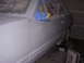 1988 Ford Mustang - A white car is being prepped for paint, with windows covered and the body taped and masked.