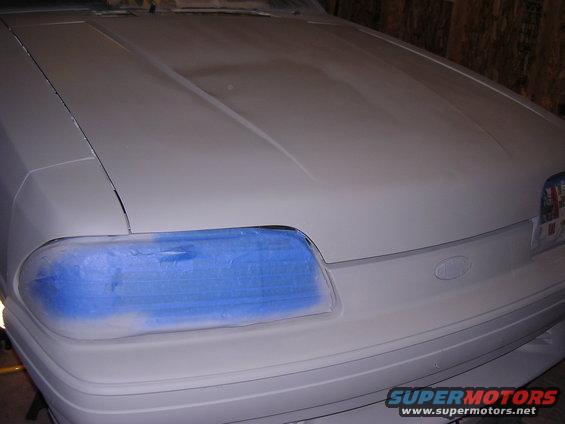 1988 Ford Mustang hood and fender with blue masking tape on headlight