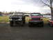 1978 Ford Bronco - A lifted black 1978 Ford Bronco is parked next to a red pickup truck.
