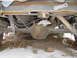 1997 Chevrolet C/K Pickup - The rear suspension and differential of a truck are visible, with some snow on the ground.