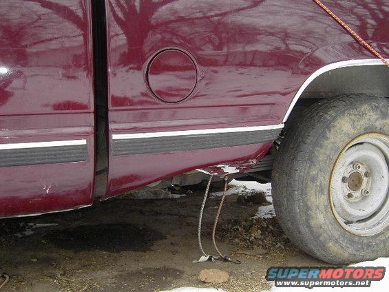 Maroon 1997 Chevrolet C/K Pickup truck side view, showing fuel door, trim, and rear wheel