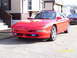 1994 Ford Probe - Front view of a red 1994 Ford Probe, showing its distinctive body style and aftermarket fog lights.