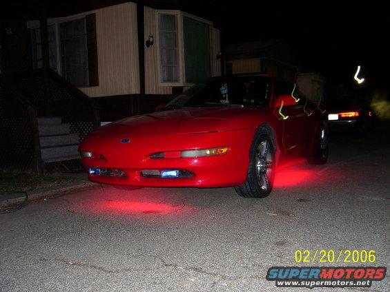 1994 Ford Probe front view with red underglow lights parked at night