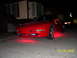 1994 Ford Probe - Red 1994 Ford Probe with custom underglow lighting is parked outside a residence.