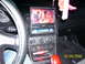 1994 Ford Probe - Dashboard view of a car interior an aftermarket Clarion entertainment system and a red gear shift knob.