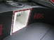 1994 Ford Probe - Custom audio setup in a vehicle's trunk features a prominent subwoofer and a unique speaker enclosure with red accents.