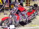 1979 Ford Bronco - A custom red motorcycle with checkerboard accents is displayed indoors.