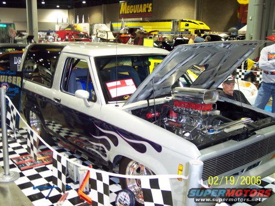 White SUV with purple flames and exposed supercharged engine. Date stamp 02/19/2006