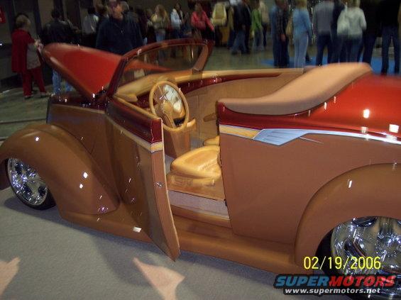 Custom hot rod convertible with wood-grain interior and red hood
