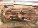 1949 Chevrolet C/K Pickup - Underside view of a heavily rusted 1949 Chevrolet C/K Pickup's rear axle and suspension system.