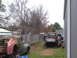 1949 Chevrolet C/K Pickup - Two vintage pickup trucks are parked in a yard, one being loaded onto a trailer.