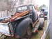1949 Chevrolet C/K Pickup - A weathered pickup truck, carrying rusty parts, is parked on a trailer next to a fence.
