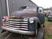 1949 Chevrolet C/K Pickup - This 1949 Chevrolet C/K Pickup truck shows significant rust and wear, with its driver's side door ajar.