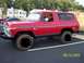 1979 Ford Bronco - A red Ford Bronco is parked in a lot with buildings and trees in the background. The date 09/12/2005 is visible.