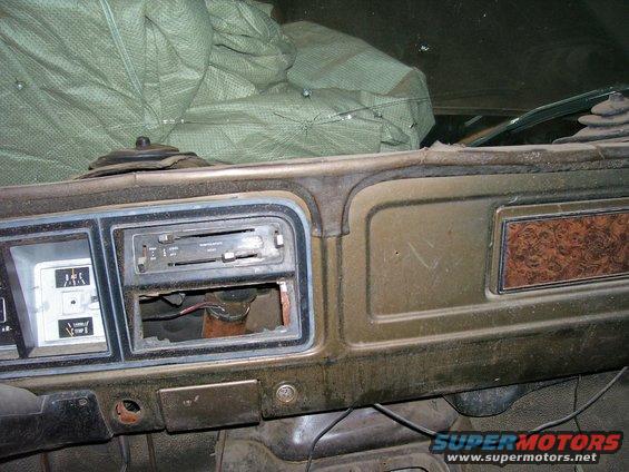 Dashboard with radio delete, gauges, and woodgrain trim. Looks like a 70s or 80s truck