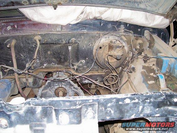 Engine bay showing brake booster and wiring