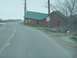 1992 Ford Bronco - A rural scene shows a barn leaning precariously to the side of a road.