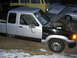 1989 Ford Ranger - This two-tone Ford Ranger has its hood up, revealing the engine compartment. The truck is parked outdoors with some snow on the ground.