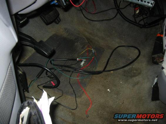 hands-free-old.jpg more useless wiring from the previous owner. that is part of the hands free system that he had on the truck. but there is only a weird shaped network jack to plug your phone into. so out it went as soon as i could. the computer for it melted some of the factory sound deadening un the floor under the carpet where it was hanging. there are also char marks on the case. 