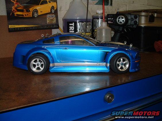 blue remote control car with silver stripe on workbench