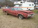 1966 Ford Ranchero - This red Ford Ranchero is in poor condition with a flat tire and open hood.