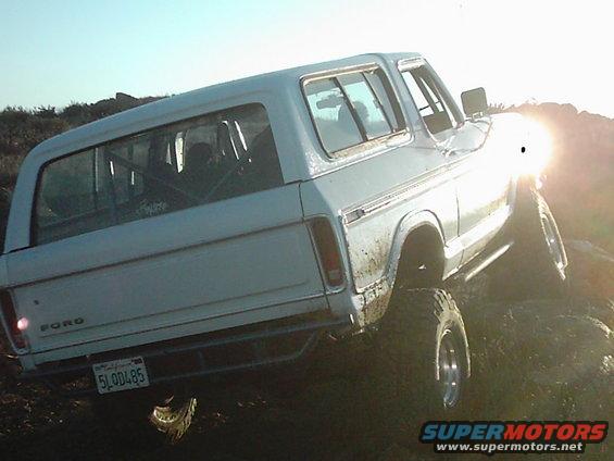White 1978 Ford Bronco rear 3/4 view, off-roading on rocks