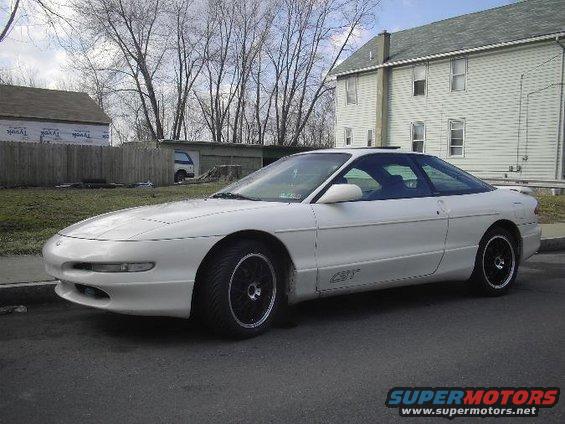 White 1996 Ford Probe coupe with black rims parked on street