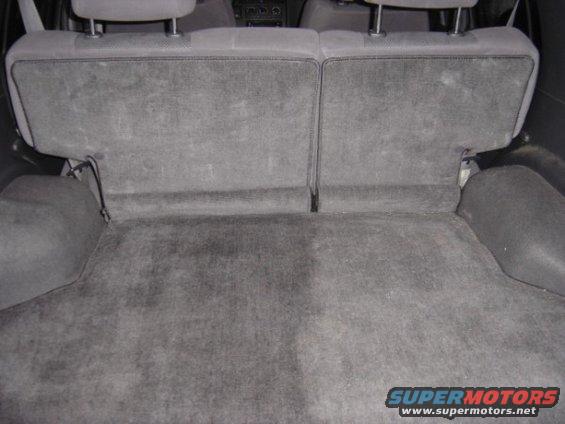 Gray carpeted cargo area with folded rear seats