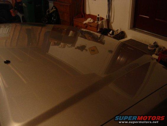 Reflection of a room on a car hood