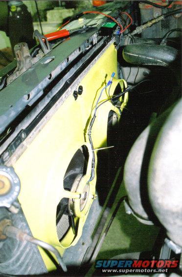 Engine bay with a yellow shroud and electric fan installed in front of the radiator