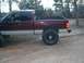 2001 Dodge 1500 - This maroon pickup truck, identified as a 2001 Dodge 1500, is shown from the side with its distinctive two-tone paint scheme and tires.