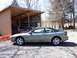1996 Ford Probe - A gray 1996 Ford Probe is parked next to a red car under an open-sided carport.
