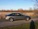 1996 Ford Probe - Side profile of a gray 1996 Ford Probe coupe parked on a dirt road with a field in the background.