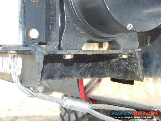 Winch mounting bracket with Rancho logo and steel cable. Supermotors.net watermark visible